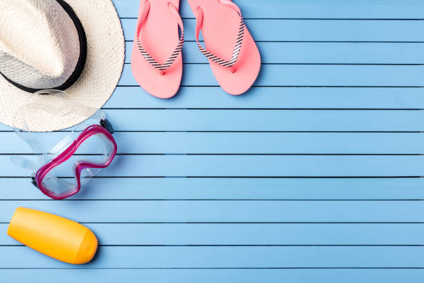 istock Summer holiday background with beach accessories on blue wooden plank 670957256