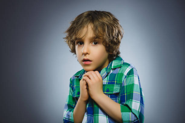 Closeup Scared and shocked little boys. Human emotion face expression stock photo
