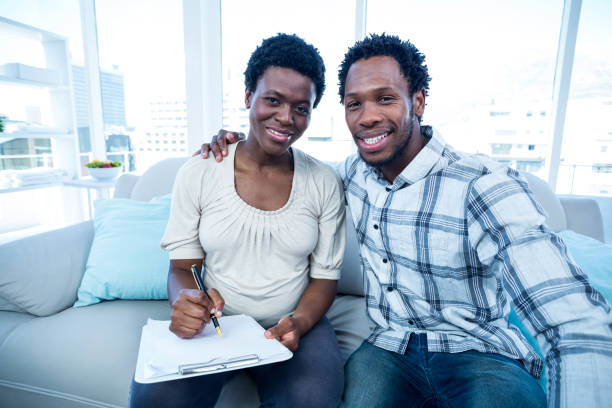istock Man with pregnant wife writing on notepad 670960538