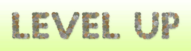 istock LEVEL UP -  Coins on green background 670964504