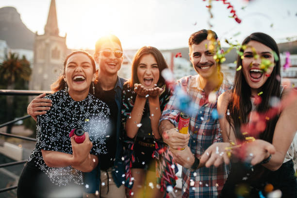 istock Friends enjoying party and  throwing confetti 670970474