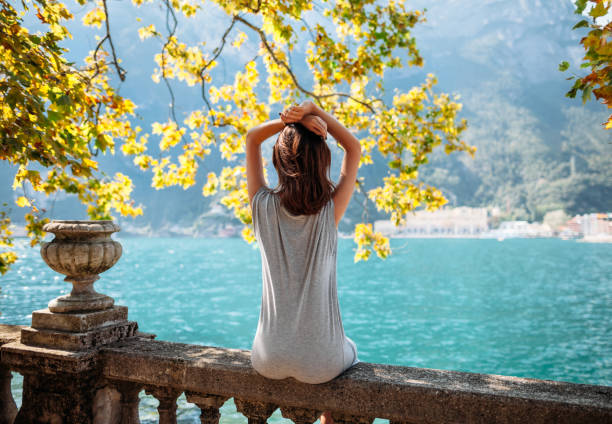 istock Young woman relaxing on beautiful Garda lake 670970606