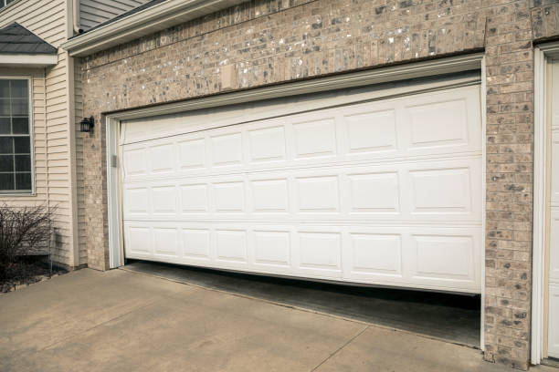 istock Broken Two Car Garage Door in Residential Home 670970676