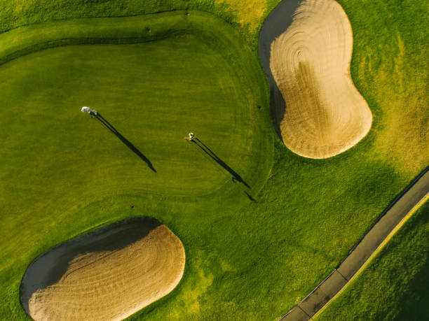istock Aerial view of golfers on putting green 670970838