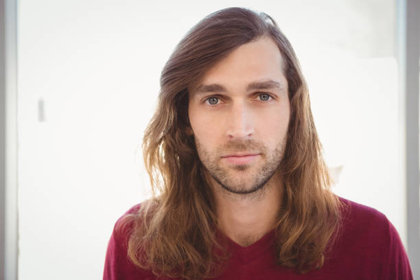 istock Portrait of confident hipster against window 670973576
