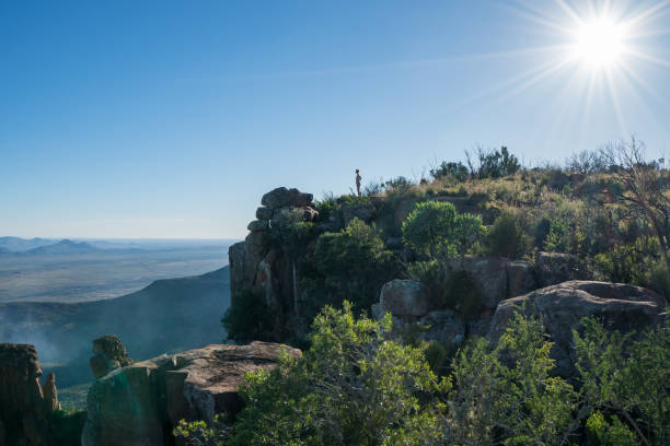 istock Distant woman standing on mountain top 670975144