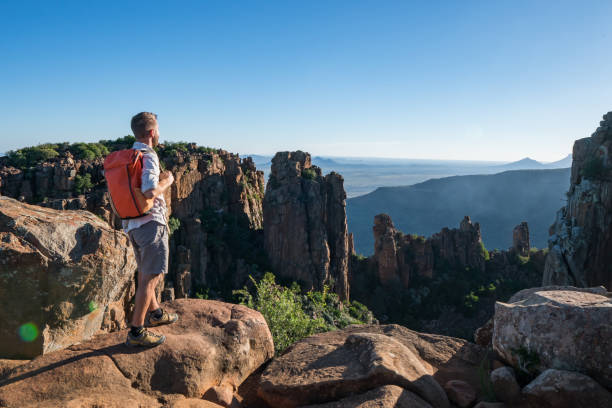 istock Hiker looking at view from mountain top 670975262