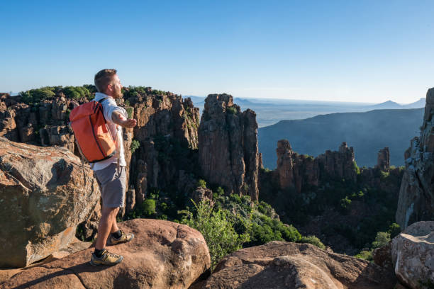istock Young man arms outstretched on mountain top 670975300