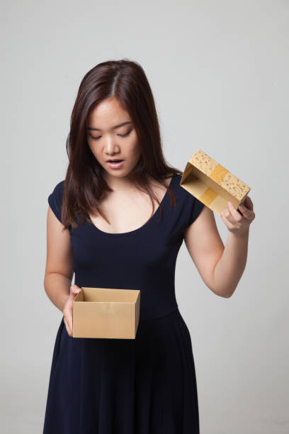 istock Young Asian woman open a gift box. 670975896
