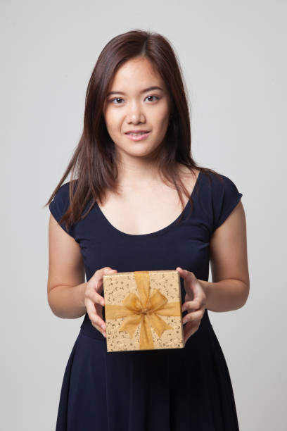istock Young Asian woman with a gift box. 670978052