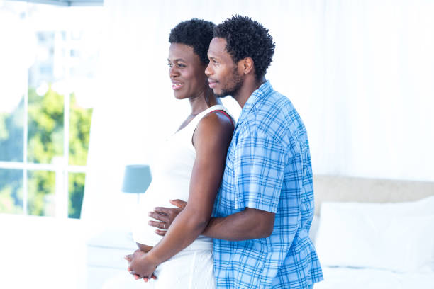 istock Husband embracing pregnant woman 670979532