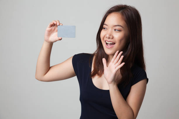 istock Young Asian woman happy with  blank card. 670981808