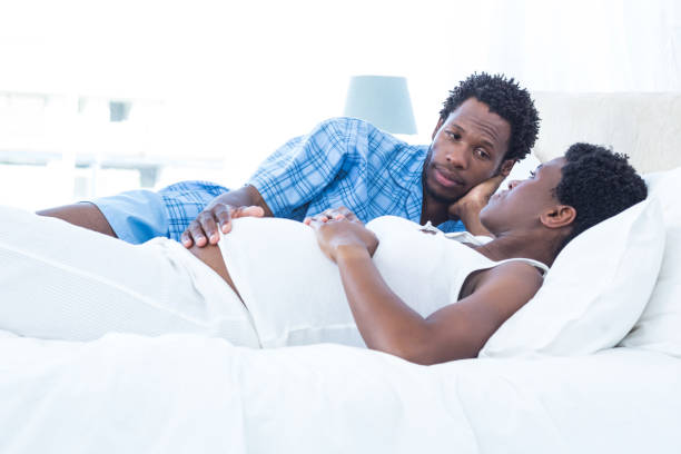 istock Man looking at pregnant woman while relaxing 670988180