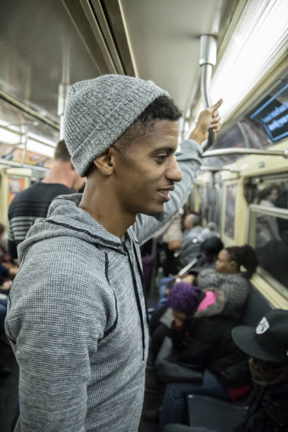 istock A candid, black man rides a crowded NYC subway train 670988368