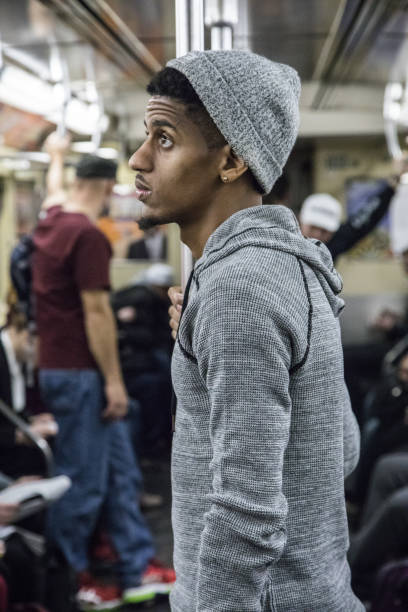 istock A candid, black man rides a crowded NYC subway train 670988392