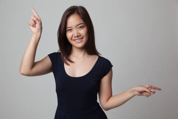 istock Young Asian woman point with two hands. 670988722
