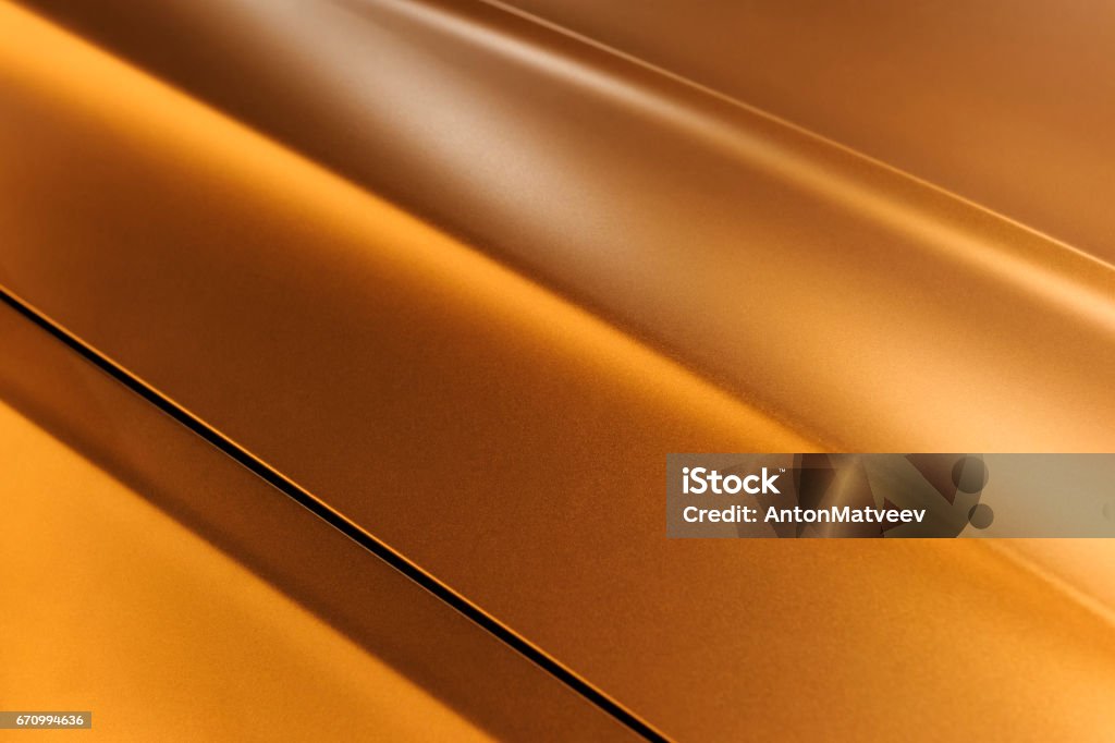 Bronze sedan bodywork Surface of bronze sport sedan car metal hood, part of vehicle bodywork, steel gradient line pattern, selective focus Car Stock Photo