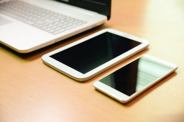 istock Soft focus notebook computer with taptet and smarth phone on wooden desk background 670994990