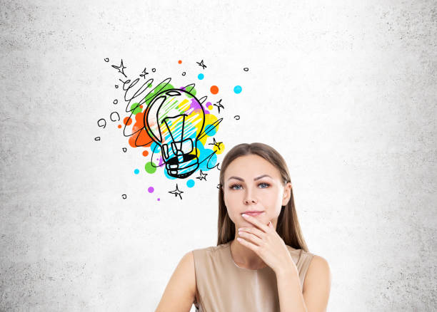 istock Woman in beige and colorful light bulb 670995680