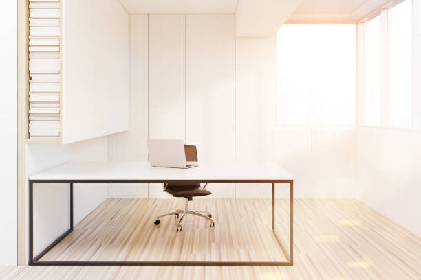 istock CEO room with a laptop, white table, toned 670998344
