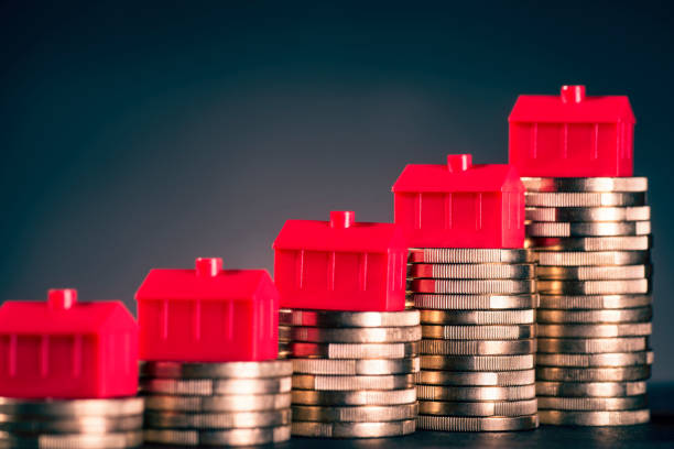istock Red houses and coins 671001936