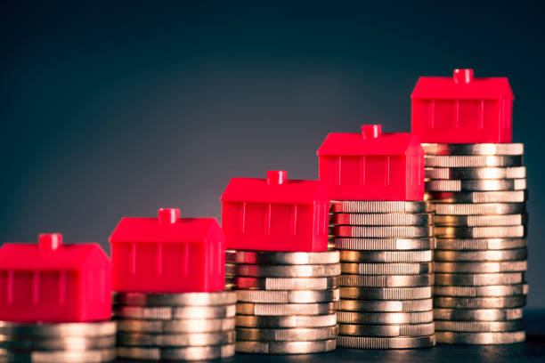 Red houses and coins stock photo