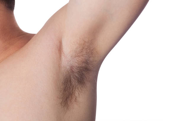 istock man raised his hand up, and shows unshaven armpit 671005152