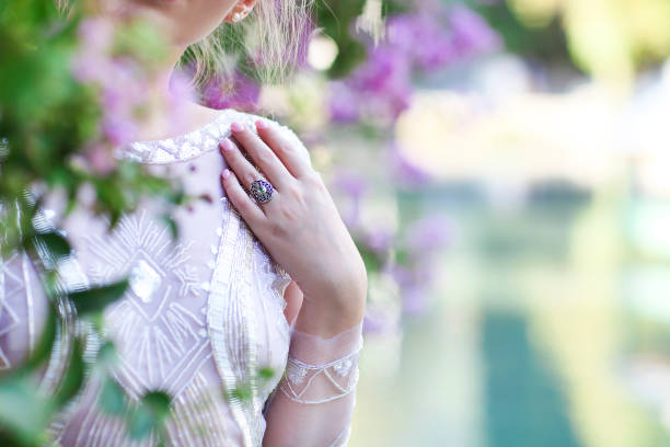 istock Beautiful bride standing by the lake at sunset 671008618