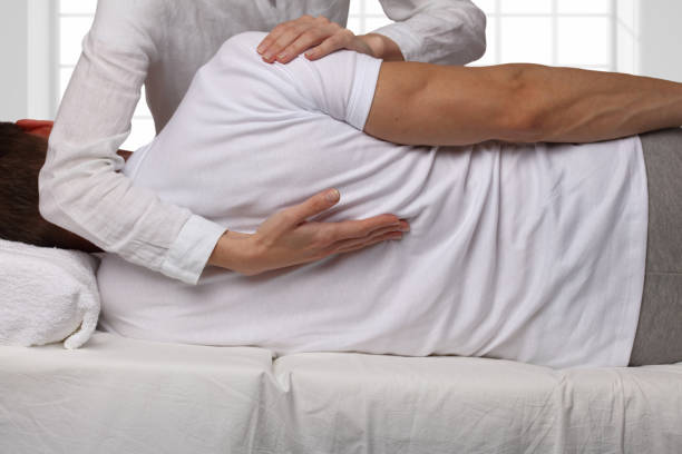 istock Man having chiropractic back adjustment. Osteopathy, Alternative medicine, pain relief concept. Physiotherapy, sport injury rehabilitation 671014434