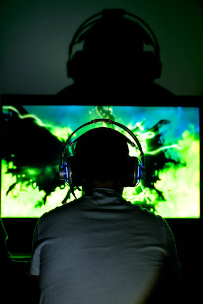 istock Young gamer playing video game wearing headphone. 671014740