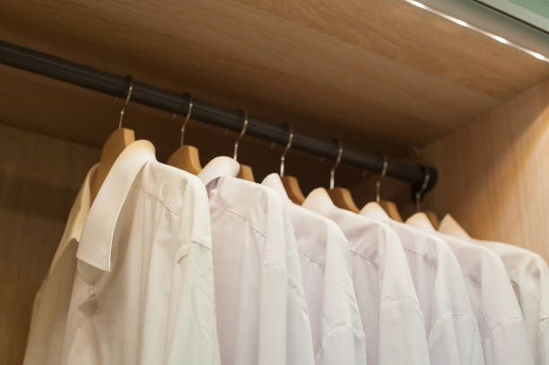 istock White men shirts hanging in closet 671018116