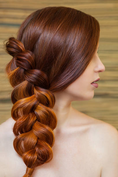 beautiful girl with long red hair, braided with a french braid - braided braids women long hair imagens e fotografias de stock