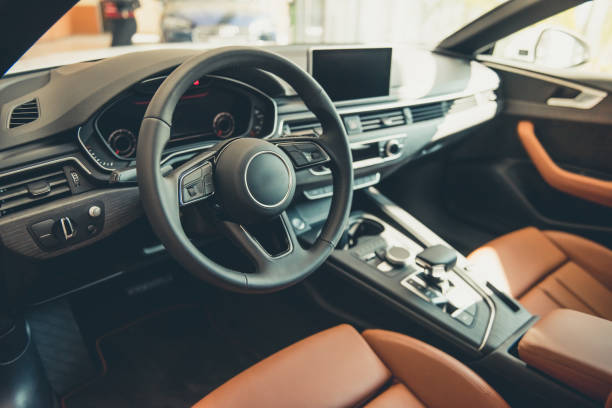 Visiting car dealership Visiting car dealership. Interior of modern automobile presented in dealership steering wheel stock pictures, royalty-free photos & images