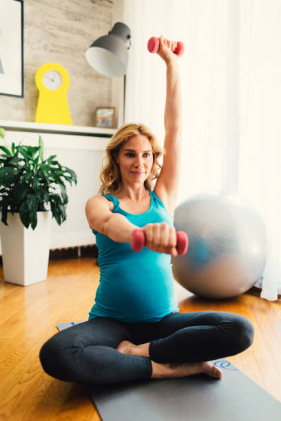 istock Pregnant Woman Exercising At Home 671027796