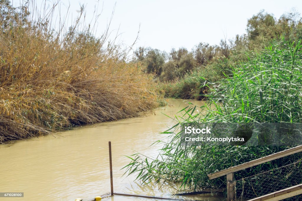 Jordan River on a hot afternoon. Jordan-Israel border Panorama of the Jordan River. A sacred river, a place of pilgrimage for Christians. The biblical baptismal site of Jesus Christ. State border of the States of Israel and Jordan Jericho Stock Photo