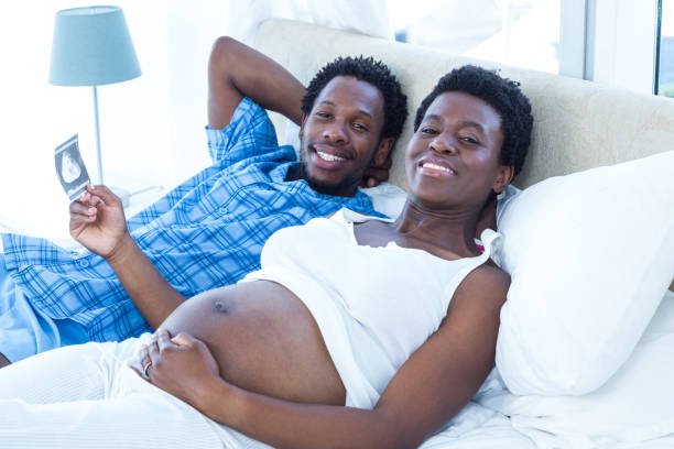 istock Smiling relaxed couple lying on bed 671028484