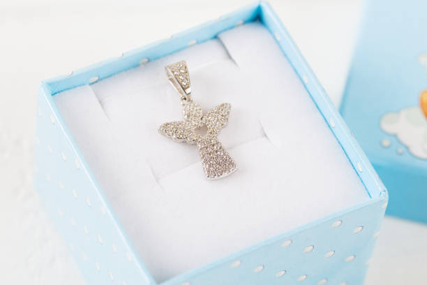Angel diamond pendant Silver pendant angel with diamonds in blue gift box. Baby shower party showers of blessings stock pictures, royalty-free photos & images