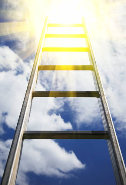 istock Ladder reaching into a blue sky and clouds 671031882