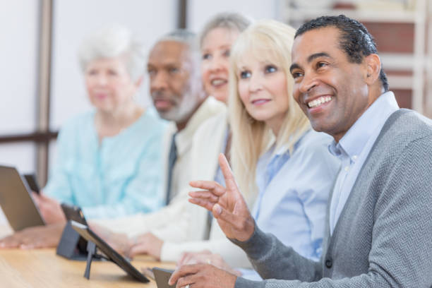 istock Handsome African American senior man attends conference 671032432