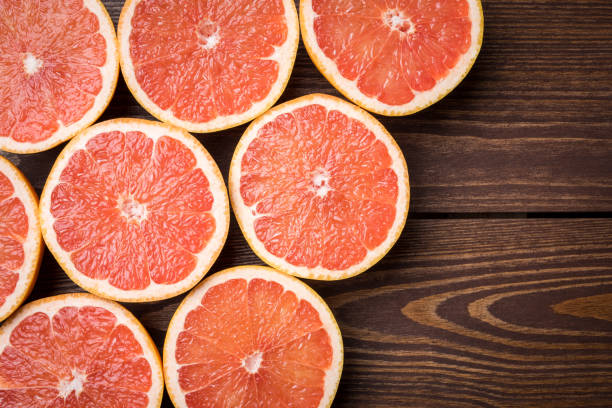 istock Grapefruits on wooden table. Food background 671038042