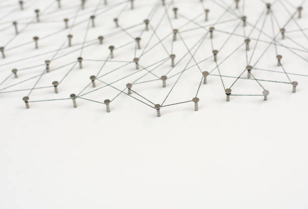 istock Linking entities. Network, networking, social media, internet communication abstract. A small network connected to a larger network. in paper linked together by cotton with a black tint 671038254