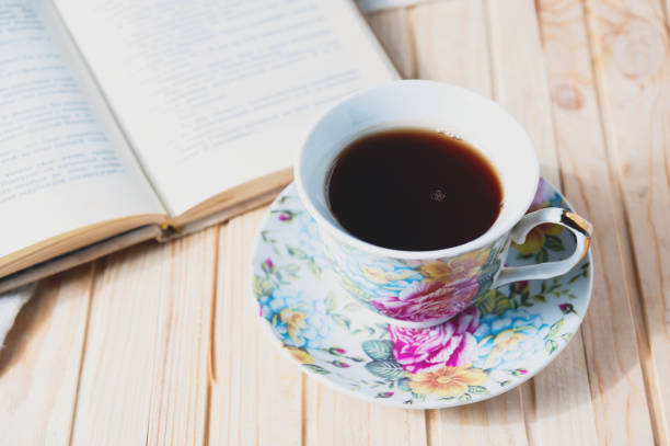 istock Cozy home still life: cup of hot coffee or tea and opened book 671039340