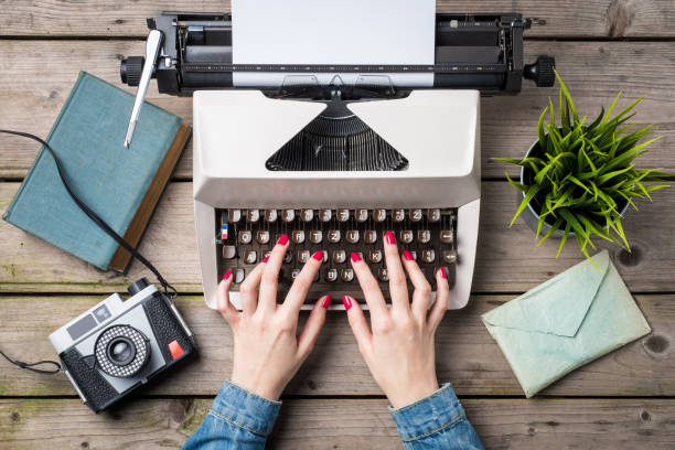 istock Woman writing on an old typewriter 671039474