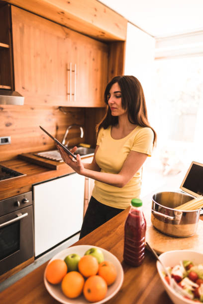 istock woman cooking in the kitchen 671047540