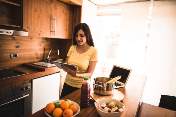 istock woman cooking in the kitchen 671047728