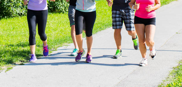istock Group of runners jogging through the park 671048254