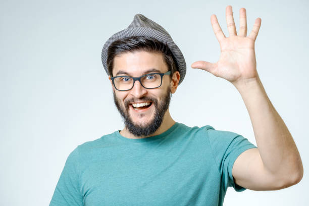 istock Young man and greeting sign isolated on gray background 671050526