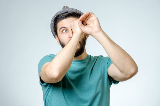 istock Happy young handsome man gesturing while standing against grey background 671050550
