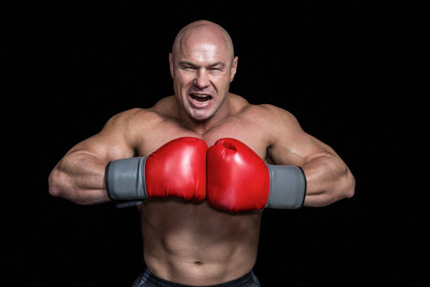 istock Angry bald boxer with punching gloves 671053656