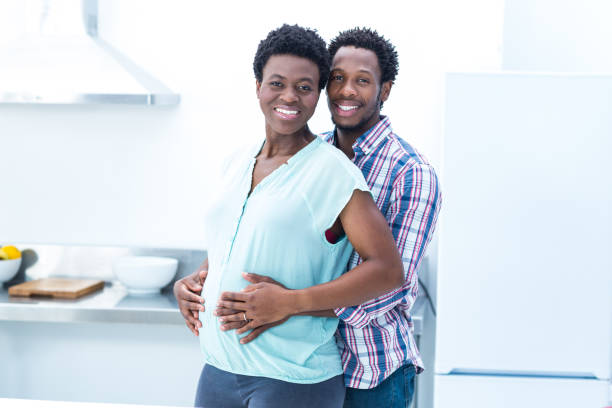 istock Portrait of man  embracing his wife while standing 671053996